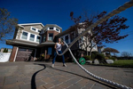 Alexa Hoovis exercises in her driveway with her virtual Fitness Trainer Dennis Guerrero on November 20th, 2020 in Oceanside, New York.  In March of 2014, Dennis Guerrero and his business partner opened a gym on Long Island. The pair shared a passion for fitness, a dream of creating a local community of like-minded people and a willingness to take a risk. Over the next six years, hundreds of members experienced and embraced a unique environment that fostered a palpable energy, helping athletes of all ages and abilities reach their potential.  The gym became a place to share achievements, work through losses and overcome illness. But like so many other businesses, it seemingly had no way of overcoming the financial impact and ongoing uncertainty of a global pandemic. With the arrival of Covid-19, the gym shut its doors back in March, with no idea when it would reopen. The owners, though, were far from done. They lent out every piece of equipment they owned to the gym’s members, continued to pay their staff and worked to set up outdoor classes in hopes of keeping their membership active and healthy. As the shutdown stretched on, it became clear that the physical gym was closed for good.  They have since reinvented themselves and are now called Life Outside the Box.  Their business model has changed drastically, and all their workouts have gone virtual.  The workouts are conducted by a small group of fitness trainers led by Guerrero.  The members pay a monthly fee and can take live Zoom fitness classes.  They are coached by the virtual trainers in real time.  More and more people have reconstructed their garages, spare rooms, backyards, and basements into home gyms since the COVID-19 pandemic hit the United States. 