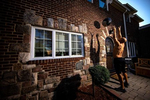  Loneil Jenkins exercises in front of his home with his virtual Fitness Trainer Dennis Guerrero on November 9th, 2020 in Oceanside, New York.  In March of 2014, Dennis Guerrero and his business partner opened a gym on Long Island. The pair shared a passion for fitness, a dream of creating a local community of like-minded people and a willingness to take a risk. Over the next six years, hundreds of members experienced and embraced a unique environment that fostered a palpable energy, helping athletes of all ages and abilities reach their potential.  The gym became a place to share achievements, work through losses and overcome illness. But like so many other businesses, it seemingly had no way of overcoming the financial impact and ongoing uncertainty of a global pandemic. With the arrival of Covid-19, the gym shut its doors back in March, with no idea when it would reopen. The owners, though, were far from done. They lent out every piece of equipment they owned to the gym’s members, continued to pay their staff and worked to set up outdoor classes in hopes of keeping their membership active and healthy. As the shutdown stretched on, it became clear that the physical gym was closed for good.  They have since reinvented themselves and are now called Life Outside the Box.  Their business model has changed drastically, and all their workouts have gone virtual.  The workouts are conducted by a small group of fitness trainers led by Guerrero.  The members pay a monthly fee and can take live Zoom fitness classes.  They are coached by the virtual trainers in real time.  More and more people have reconstructed their garages, spare rooms, backyards, and basements into home gyms since the COVID-19 pandemic hit the United States. 