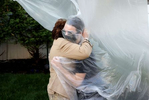 James Grant hugs his Grandmother Mary Grace Sileo through a plastic drop cloth hung up on a homemade clothes line during Memorial Day Weekend on May 24, 2020 in Wantagh, New York.  It is the first time they have had contact of any kind since the coronavirus COVID-19 pandemic lockdown started in late February.  