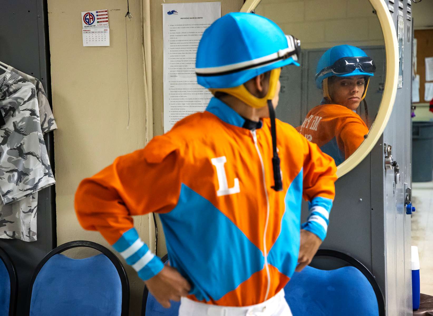 Student Jockey Bryan Torres looks at himself in the mirror in preparation for his race at the Vocational Equestrian Agustín Mercado Reverón School located in the Hipódromo Camarero on November 18, 2022 in Canovanas, Puerto Rico. The Vocational Equestrian Agustín Mercado Reverón School has produced some of the best jockeys in the world but also prepares students for a wide range of equestrian jobs on a tuition-free basis. 