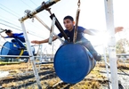 Jockey student Christian Maldonado (Front) balances on a steel drum suspended in the air by a series of springs to simulate riding a horse at the Vocational Equestrian Agustín Mercado Reverón School located in the Hipódromo Camarero on November 17, 2022 in Canovanas, Puerto Rico. The Vocational Equestrian Agustín Mercado Reverón School has produced some of the best jockeys in the world but also prepares students for a wide range of equestrian jobs on a tuition-free basis.