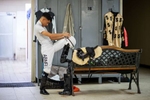 Abnel Bocachica prepares in the locker room before his race at the Vocational Equestrian Agustín Mercado Reverón School located in the Hipódromo Camarero on November 18, 2022 in Canovanas, Puerto Rico. The Vocational Equestrian Agustín Mercado Reverón School has produced some of the best jockeys in the world but also prepares students for a wide range of equestrian jobs on a tuition-free basis.  