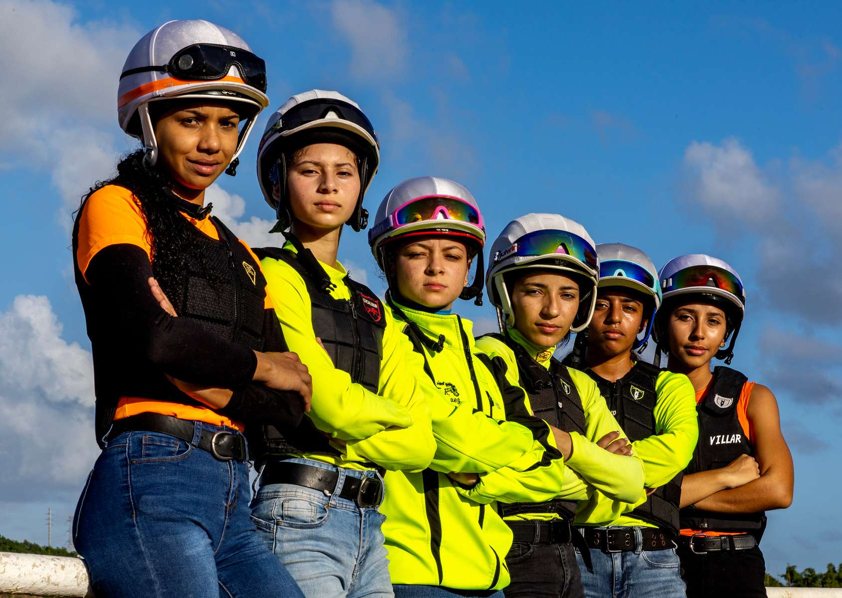 From (L-R) Student Exercise Riders and Student Jockeys Kiara Melendez, Yalexamarie Cintron, Elbaliz Rodriguez, Valeria Melendez, Jolines Ramos, and Valeria Acevedo pose for a portrait on the main racetrack at the Vocational Equestrian Agustín Mercado Reverón School located in the Hipódromo Camarero on November 16, 2022 in Canovanas, Puerto Rico. The Vocational Equestrian Agustín Mercado Reverón School has produced some of the best jockeys in the world but also prepares students for a wide range of equestrian jobs on a tuition-free basis. 