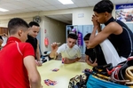 A group of Student Jockeys play cards in the locker room before their race at the Vocational Equestrian Agustín Mercado Reverón School located in the Hipódromo Camarero on November 18, 2022 in Canovanas, Puerto Rico. The Vocational Equestrian Agustín Mercado Reverón School has produced some of the best jockeys in the world but also prepares students for a wide range of equestrian jobs on a tuition-free basis.  