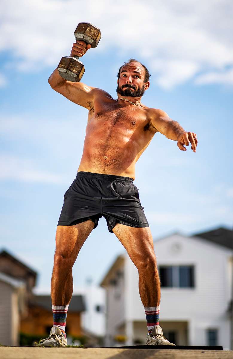 CrossFit athlete Rick Loomis performs a Russian Kettlebell swing during a Life Outside the Box photo shoot on July 1, 2021 in Long Beach, New York.