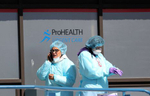 Medical professionals take a break at a drive-thru coronavirus testing site run by  ProHealth Care on April 06, 2020 in Jericho, New York. The World Health Organization declared coronavirus (COVID-19) a global pandemic on March 11th. 