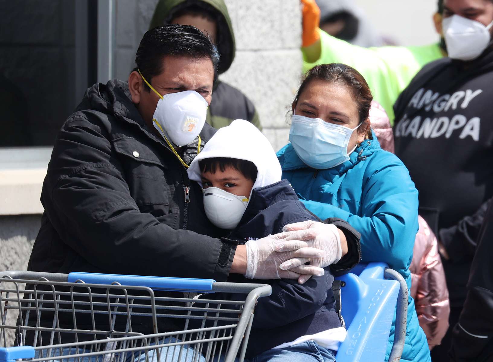 People wearing masks and gloves wait to enter Walmart on April 17, 2020 in Uniondale, New York. The World Health Organization declared coronavirus (COVID-19) a global pandemic on March 11th.  