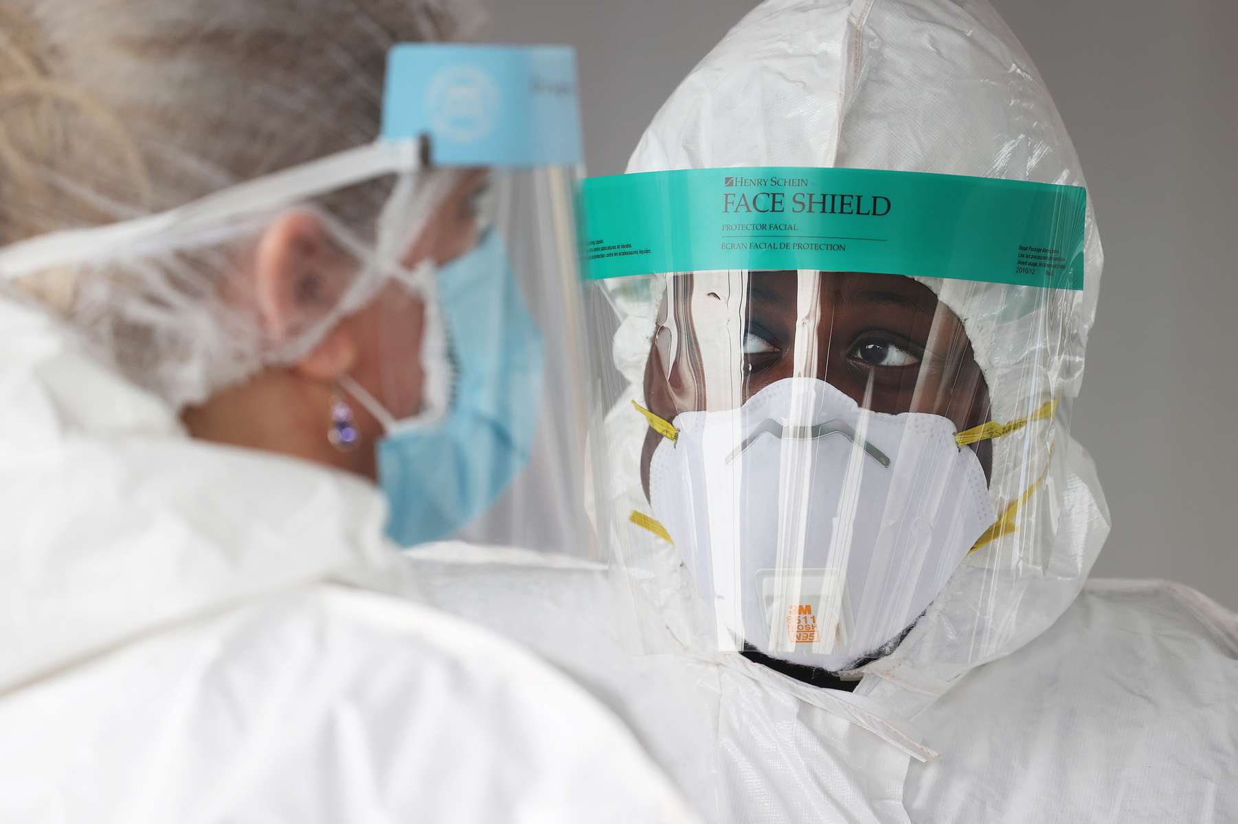 Health Care Workers converse at the Pro Health Urgent Care coronavirus testing site on April 30, 2020 in Wantagh, New York.  The World Health Organization declared coronavirus (COVID-19) a global pandemic on March 11th. 