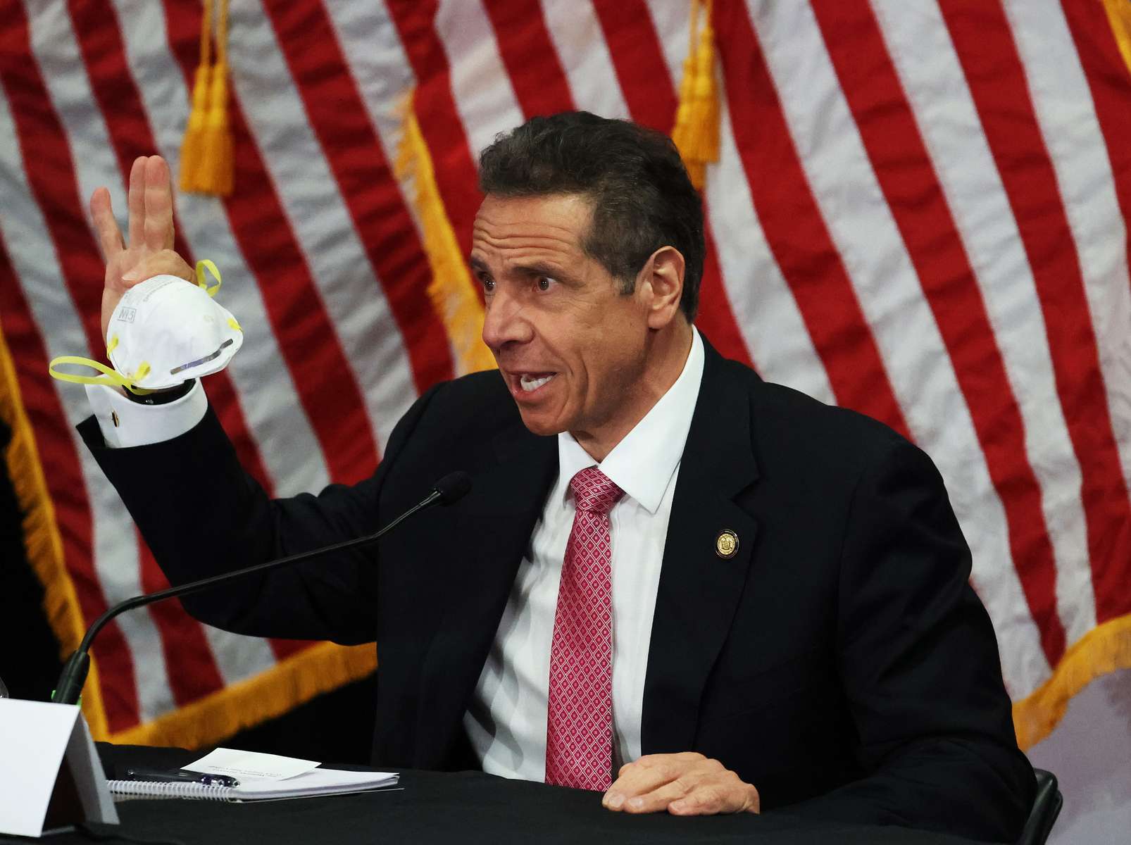New York Governor Andrew Cuomo displays the N-95 mask he wears during a Coronavirus Briefing At Northwell Feinstein Institute For Medical Research on May 06, 2020 in Manhasset, New York. 