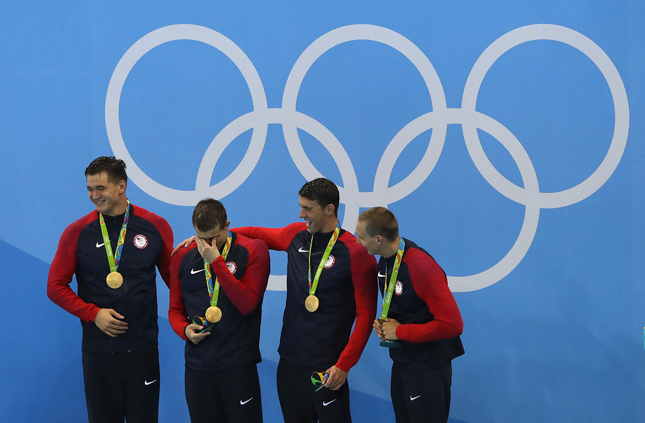 Gold medalists Nathan Adrian, Ryan Held, Michael Phelps and Caeleb Dressell of the United States celebrate on the podium during the medal ceremony for the Final of the Men's 4 x 100m Freestyle Relay on Day 2 of the Rio 2016 Olympic Games at the Olympic Aquatics Stadium on August 7, 2016 in Rio de Janeiro, Brazil. 