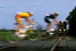 Cyclists race across a railroad crossing on to the path of an oncoming train during Stage 2 of the Tour DuPont between Fredricksburg in Maryland to Richmond on May 6, 1996 in Virginia, USA.  