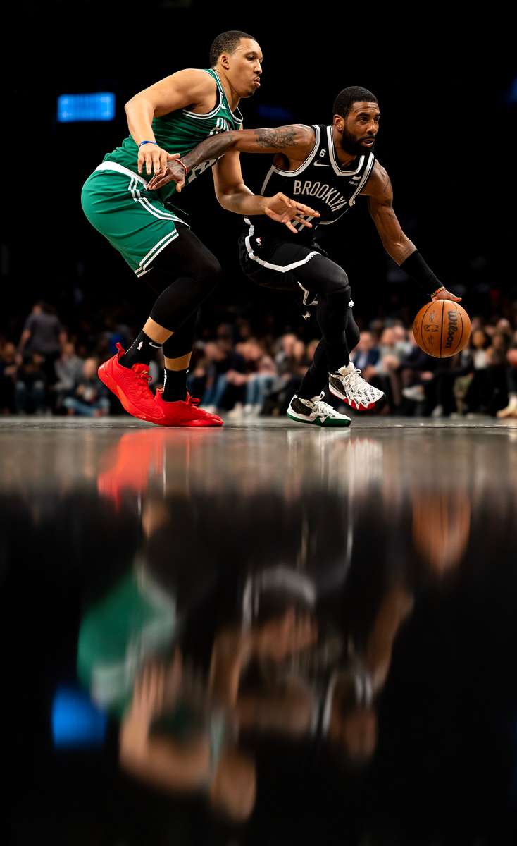 Kyrie Irving #11 of the Brooklyn Nets drives against  Grant Williams #12 of the Boston Celtics during their game at Barclays Center on January 12, 2023 in New York City.  