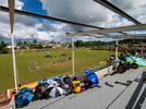 CAGUAS, PUERTO RICO - NOVEMBER 10: Parents watch their kids play Little League Soccer under a damaged roof caused by Hurricane Maria.  They are using umbrellas to shield themselves from the Sun.  on November 10, 2018 in Caguas, Puerto Rico. The effort continues in Puerto Rico to remain and rebuild more than one year after the Hurricane Maria hit and devastated the island on September 20, 2017. The official number of deaths from the disaster is 2,975. 