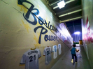 SAN JUAN, PUERTO RICO - NOVEMBER 15:  A young fan runs with a bag of popcorn into the stadium next to a hallway leading to the field with a mural on the wall with the words Boricua Power and the Jerseys of famous MLB Puerto Rican baseball players Roberto Clemente and Orlando Cepeda  during the game between the Gigantes De Carolina  against the Indios De Mayaguez during opening day of the Professional Baseball League of Puerto Rico at Hiram Bithorn Stadium on November 15, 2018 in San Juan, Puerto Rico. The effort continues in Puerto Rico to remain and rebuild more than one year after the Hurricane Maria hit and devastated the island on September 20, 2017. The official number of deaths from the disaster is 2,975. 