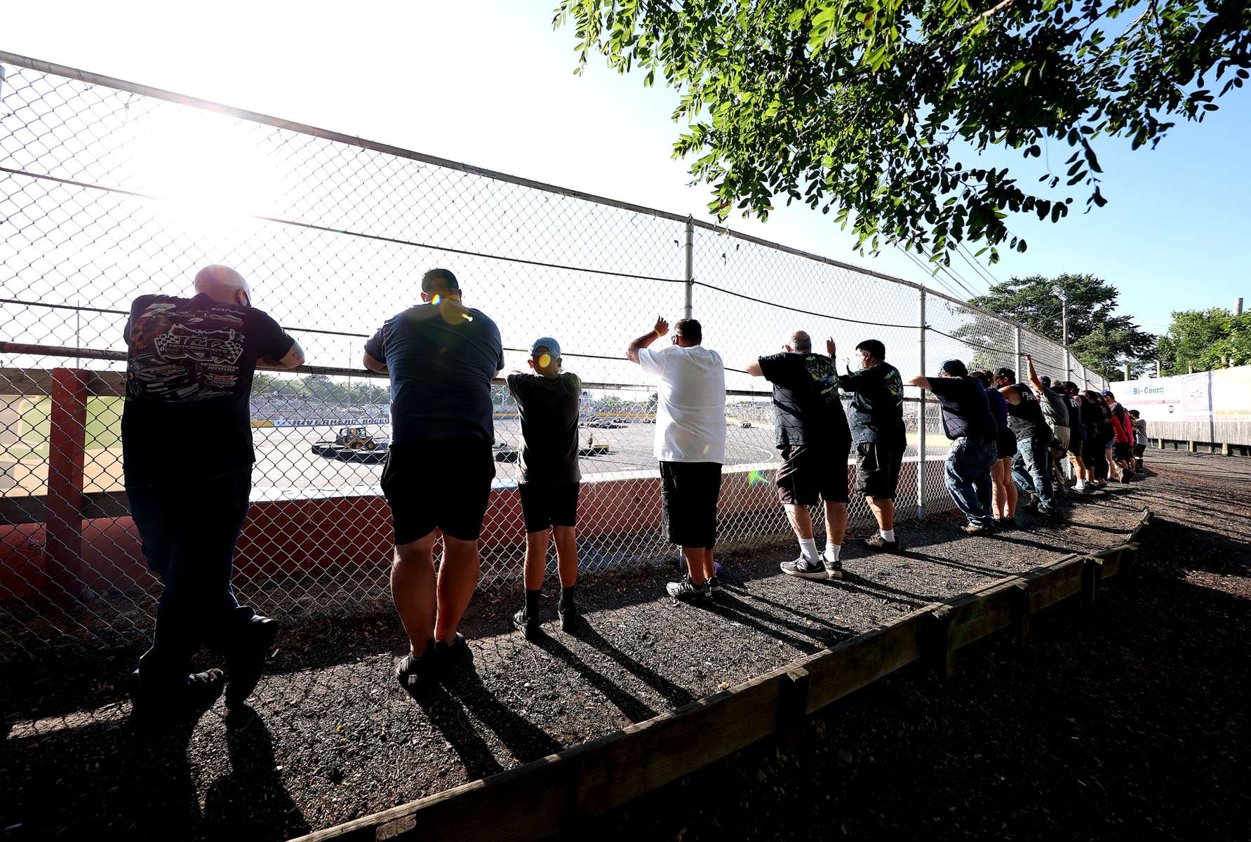 Fans watch cars racing around the track during NASCAR Advance Auto Series Opening Night at Riverhead Raceway on August 01, 2020 in Riverhead, New York.  The race track had been closed due to the coronavirus COVID-19 pandemic.  More than 4,585,258 people in the United States alone have been infected with the coronavirus and at least 154,000 have died. 