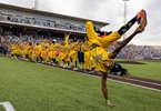 First Base Coach/Dance instructor Maceo Harrison of the Savannah Bananas performs a dance routine their game against the Party Animals at Richmond County Bank Ball Park on August 12, 2023 in New York City. 