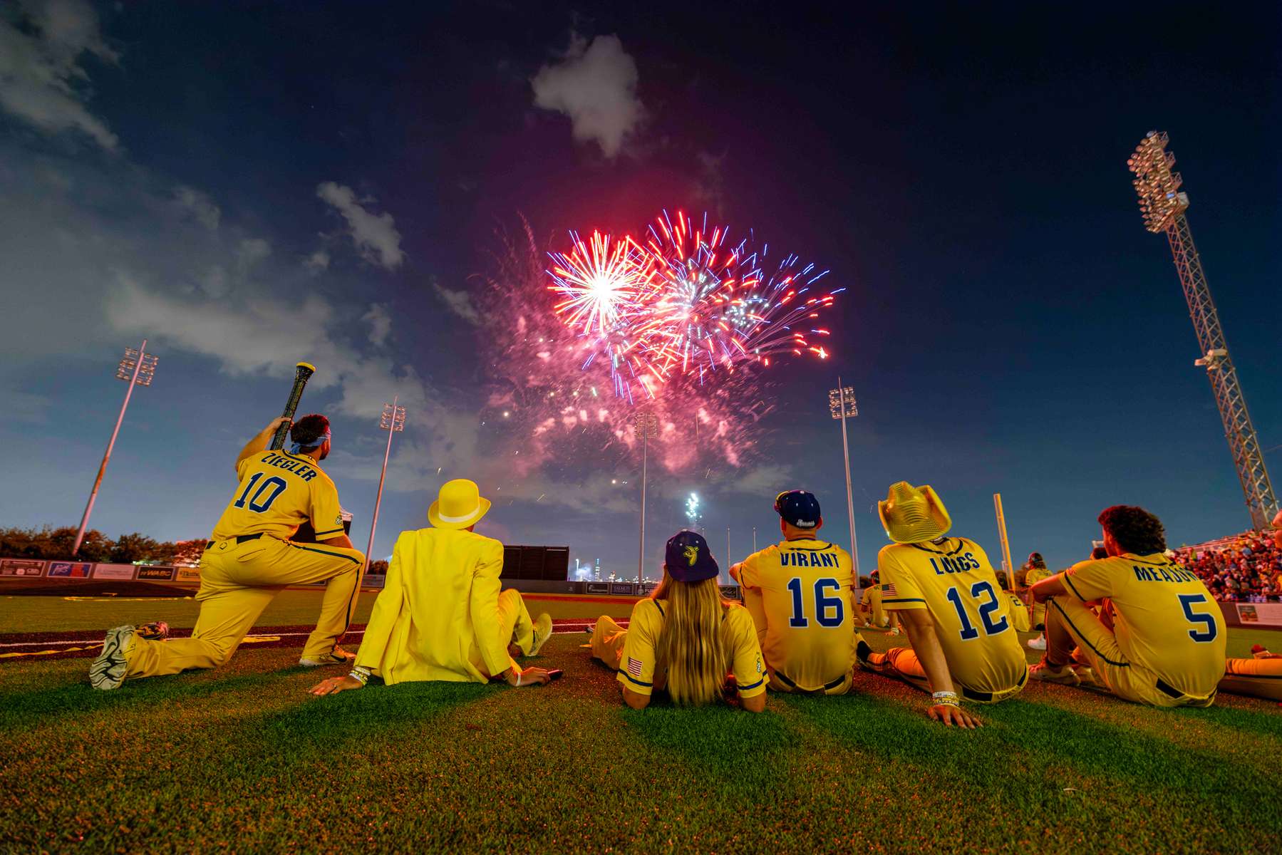 Savannah Bananas owner Jesse Cole sits with his players to watch a fireworks show after their game against the Party Animals at Richmond County Bank Ball Park on August 12, 2023 in New York City. 