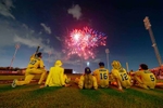 Savannah Bananas owner Jesse Cole sits with his players to watch a fireworks show after their game against the Party Animals at Richmond County Bank Ball Park on August 12, 2023 in New York City. 
