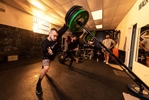 Thomas De Giuli (L) and Marcello Erickson perform a Landmine exercise at Hiit House gym on April 03, 2022 in Garden City, New York.  The athletes use unconventional fitness training methods when they exercise. 