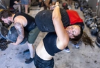 Alexa Hoovis throws a sandbag over her shoulder during a workout at the Strength Factory gym on July 4, 2022 in Baldwin, New York.  The athletes use unconventional fitness training methods when they exercise.  