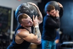 Thomas De Giuli (L) and Marcello Erickson each lift a medicine ball at Hiit House gym on March 30th, 2022 in Garden City, New York.  The athletes use unconventional fitness training methods when they exercise. 
