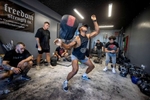 Martin Marquez throws a sandbag over his shoulders during a workout at the Strength Factory gym on July 4, 2022 in Baldwin, New York.  The athletes use unconventional fitness training methods when they exercise. 