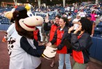 Tela O'Donnell, Sara McMann, and and Head Coach Terry Steiner of the US Olympic Woman's Wrestling team greet Staten Island Yankees team mascot at their home opener on June 22, 2004 in Staten Island, New York. 
