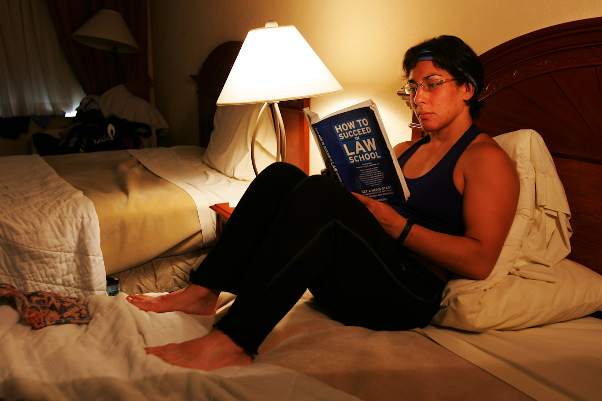 Patricia Miranda, of the US Olympic Woman's Wrestling team, and soon to be law student at Yale University this fall reads her book between training sessions at their training camp at at the Staten Island Hotel on June 26, 2004 in Staten Island, New York. 