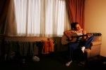 Tela O'Donnell, of the US Olympic Womans Wrestling team practices playing her guitar between training sessions on June 24, 2004 in Staten Island, New York. 
