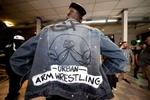 Gerren Nixon of the Urban Arm Wrestling League, displays his jacket  during the 98% Protest Series Arm Wrestling tournament on May 15, 2021 in Philadelphia Pennsylvania.  Gerren Nixon, 44, of Wyandanch, formed the Urban Arm Wrestling League, a company that sponsors tournaments and promotes the sport on Long Island, in 2019.  He has been a fan of the sport since he saw the Sylvester Stallone movie {quote}Over the Top{quote} in the 1980's.  Arm wrestling is popular around the world, particularly in Eastern Europe, but it remains a largely underground event in the United States, with few sponsors and no television coverage of tournaments.  The name of his Arm Wrestling team is called the Prime Time Pullers.  The team is a multicultural combined group of Men and Women.  Nixon said there are very few arm wrestlers of color and he believes he’s the only Black arm wrestling league owner.  He is working to build a network of local teams to compete across the country and it is a dream of his to be able to one day crown a homegrown champion from Long Island. 