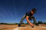 A student Umpire cleans home plate before participationg  in a simulated baseball game during the Jim Evans Academy of Professional Umpiring on January 27, 2011 at the Houston Astros Spring Training Complex  in Kissimmee, Florida. 