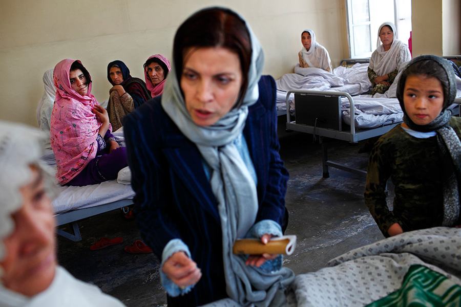 A female social worker (center) visits the women’s psychiatric ward.  The government-run hospital currently possesses only1 kind of antidepressant and 2 kinds of antipsychotic medicines, which were donated by foreign countries.