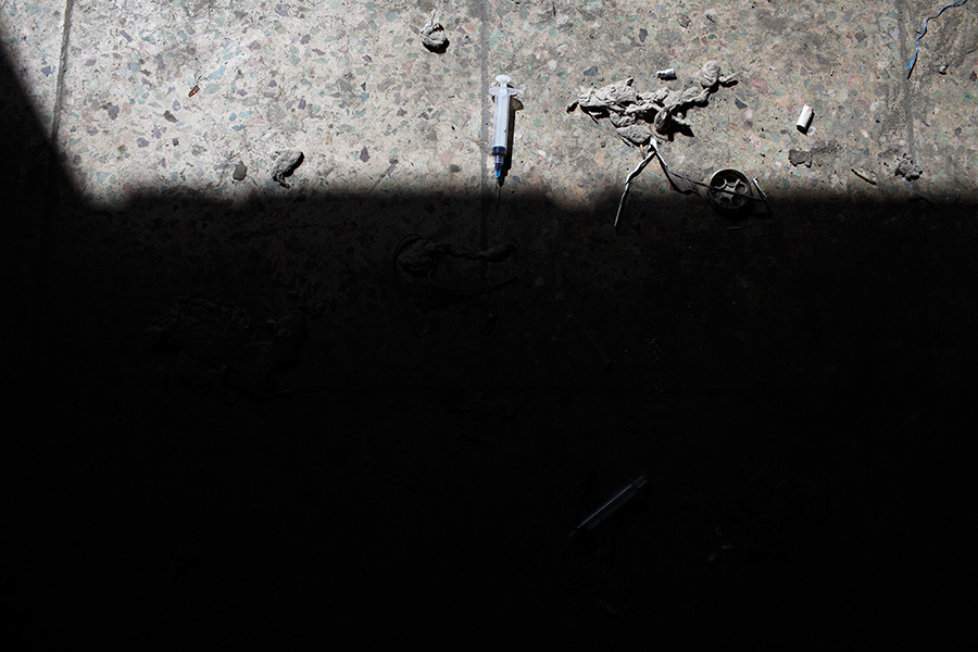 A used syringe lies on the floor of the destroyed Russian Cultural Center in Kabul, Afghanistan.  In the streets of Kabul, one gram of heroin goes for about 200 to 250 Afghani, which is about US$4.00 to 5.00.