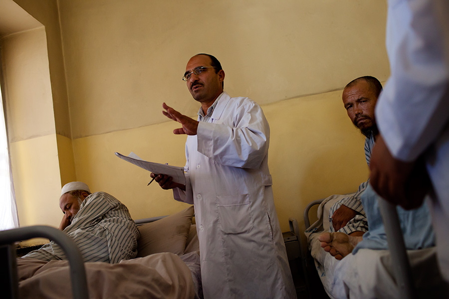 Doctors and medical staffs examine patients at the men’s psychiatric ward.
