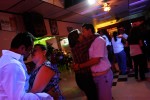 Couples kiss as they dance to the music at a Hispanic restaurant bar.