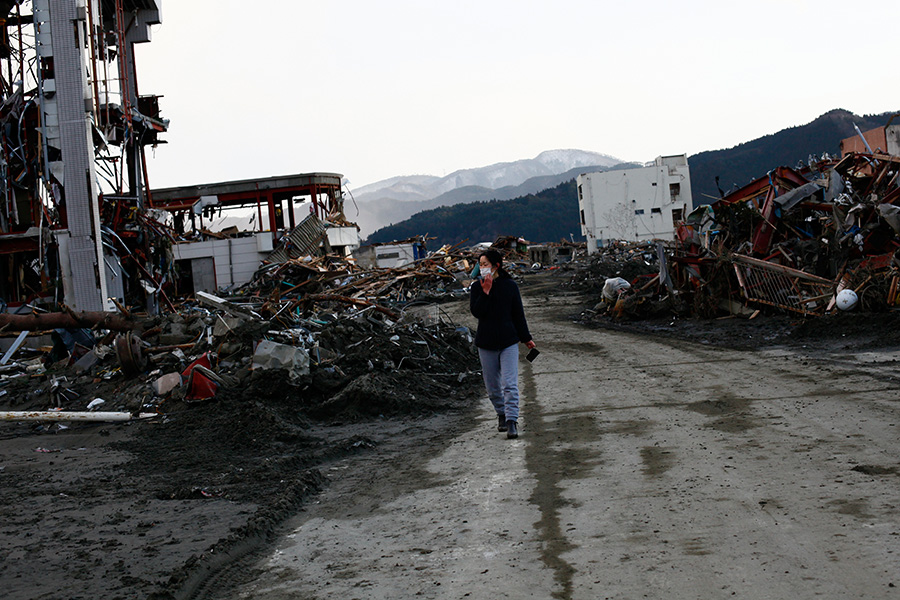 A local resident searches for her family's belongings amongst the wreckage in Rikuzentakata, Iwate.  She stated that she would like to find family pictures the most.  