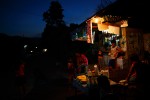 Locals gather at a small roadside market in a rural village in Castillejos, Philippines in the late evening.