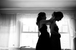 bride and bridesmaid get ready at a wedding venue in maine. by vermont wedding photographer monica donovan.