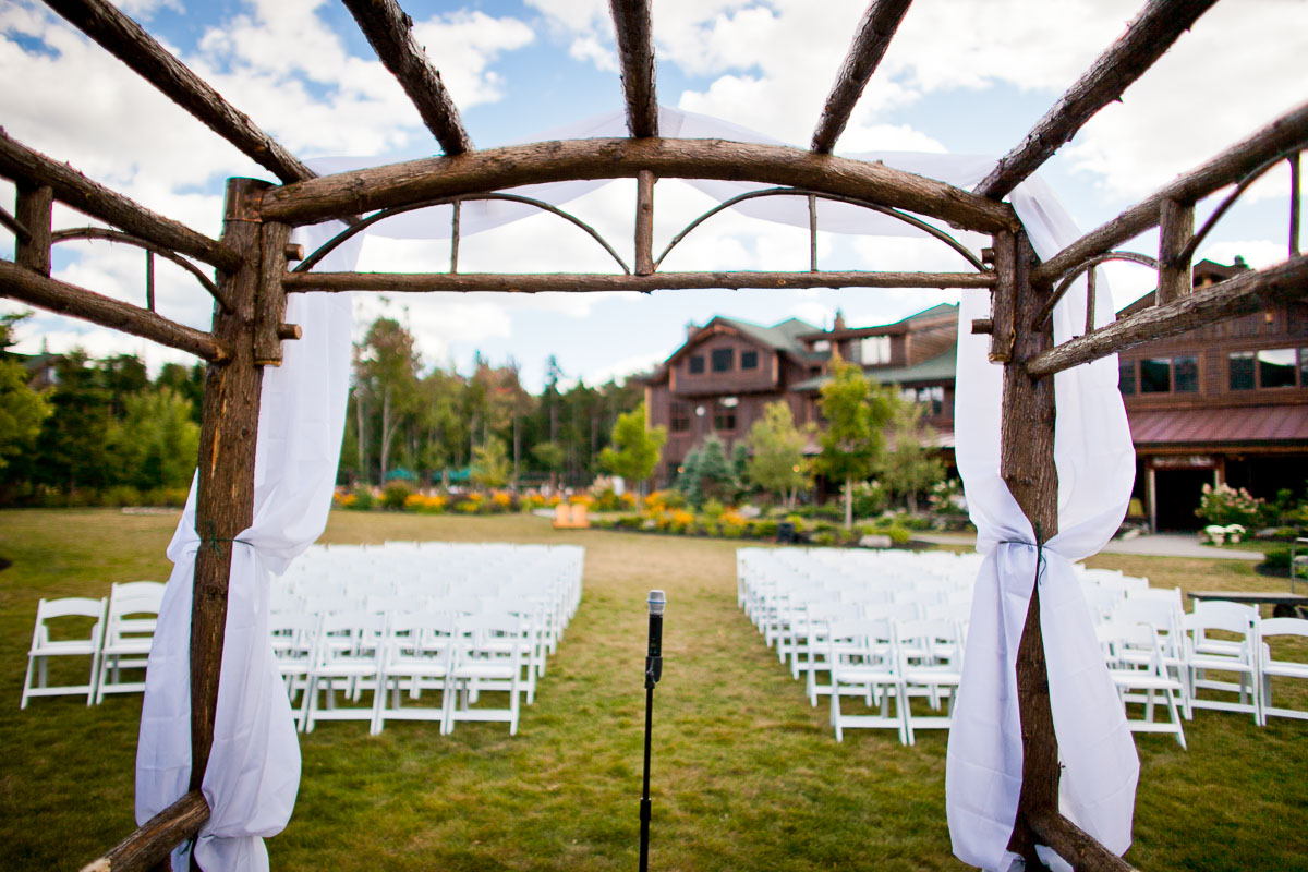 A microphone stands before an empty ceremony site at Kelly and Sepehr's wedding. Whiteface Lodge in Lake Placid, New York. by Vermont wedding photographers Eve Event Photography