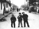 Three boys playing in the street outside their school in Xian province, China