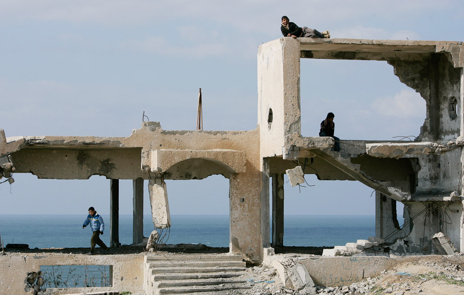 Children in the Gaza Strip play on the remains of a police station that was destroyed by an Israeli F-16.