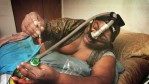 Wearing a breathing apparatus, former Chester city firefighter Rudy Hollis, disposes of an insulin syringe which helps controls his diabetes. Hollis also suffers from periodic heart stoppages, a complication from a kidney transplant. The suspected cause of his illnesses was fighting the Wade dump site fire in 1978 where emergency responders were exposed to thousands of drums of burning toxic waste without protective clothing. The fire is the suspected cause of the deaths and illnesses of dozens of Chester’s emergency personnel.