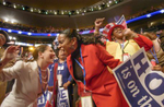 Louisiana delegates Yvonne Atkinson Gatescneter and Karen Sommer Shalett, left, dance at the conclusion of John Edwards’s speech at the 2004 Democrat Convention.