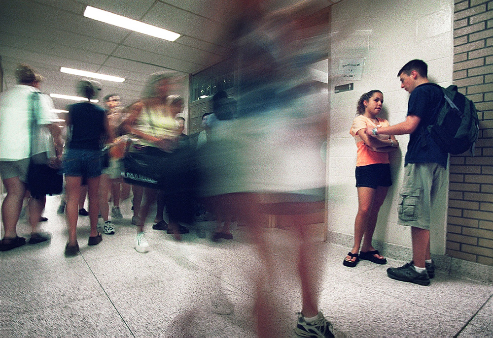 Students Erica Varnenti and Devon Coughlin, right, meet in a crowded hallway during a change of class at Shawnee Regional High School in Tabernacle, NJ.