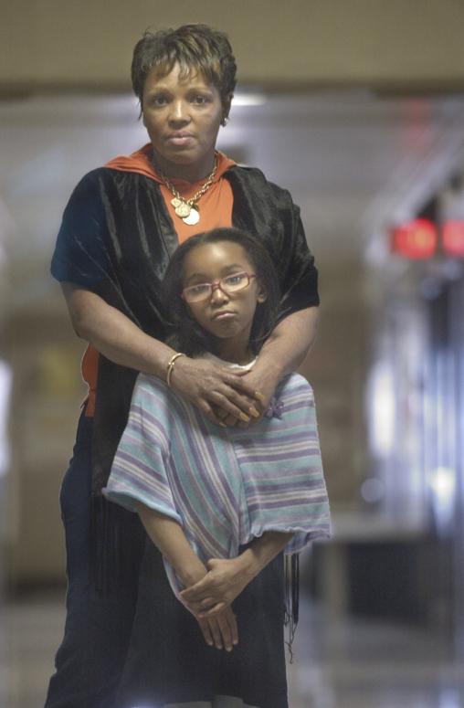Standing in a hallway of the administration building of the School District of Philadelphia are Malani Sanders and her grandmother Donna Trice. Sanders an 8 year-old was expelled from her school for bringing a small knife to class.  She tearfully pleaded to be re-instated at her former school.