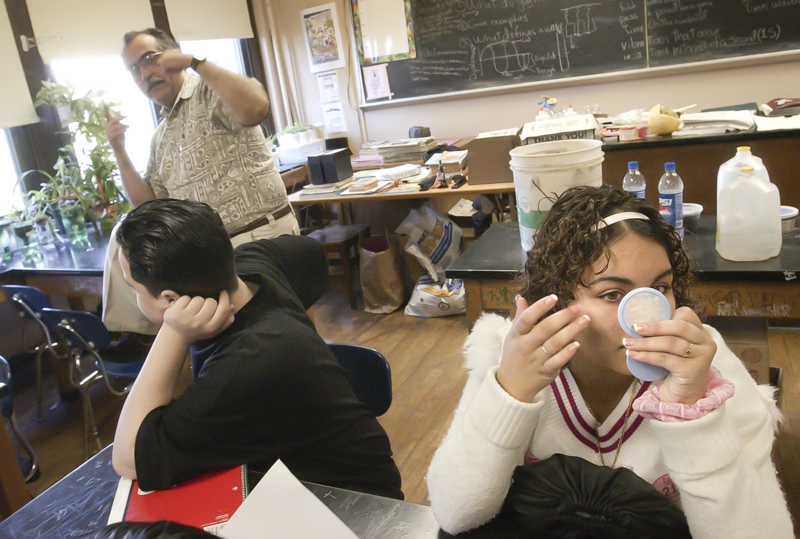 During a discussion of hydroponics, Joel Martinez, left, listens to teacher Jose Diaz's instructions while Jesse Carrano checks her makeup at Olney High School in Philadelphia, PA. 