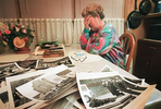 Judy McLaughlin, surrounded by photos from the 1987 funeral of her husband, Vincent “Moose” McLaughlin. A Chester fire captain, McLaughlin, without a respirator, lead a group of firefighters inside the blazing warehouse at the Wade dump. 