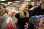 On Black Friday, at 5:23 AM, shopper Susan Turco, attempts to maneuver to the checkout counter at KB Toys in Philadelphia.