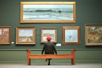 A docent views paintings of early 20th Century Impressionists at the Pennsylvania Academy of Fine Arts in Philadelphia.