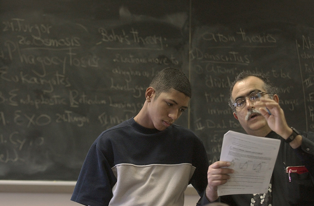 Jose Diaz explains an assignment about cell structure to Luis Angel Viera in his fourth period class.